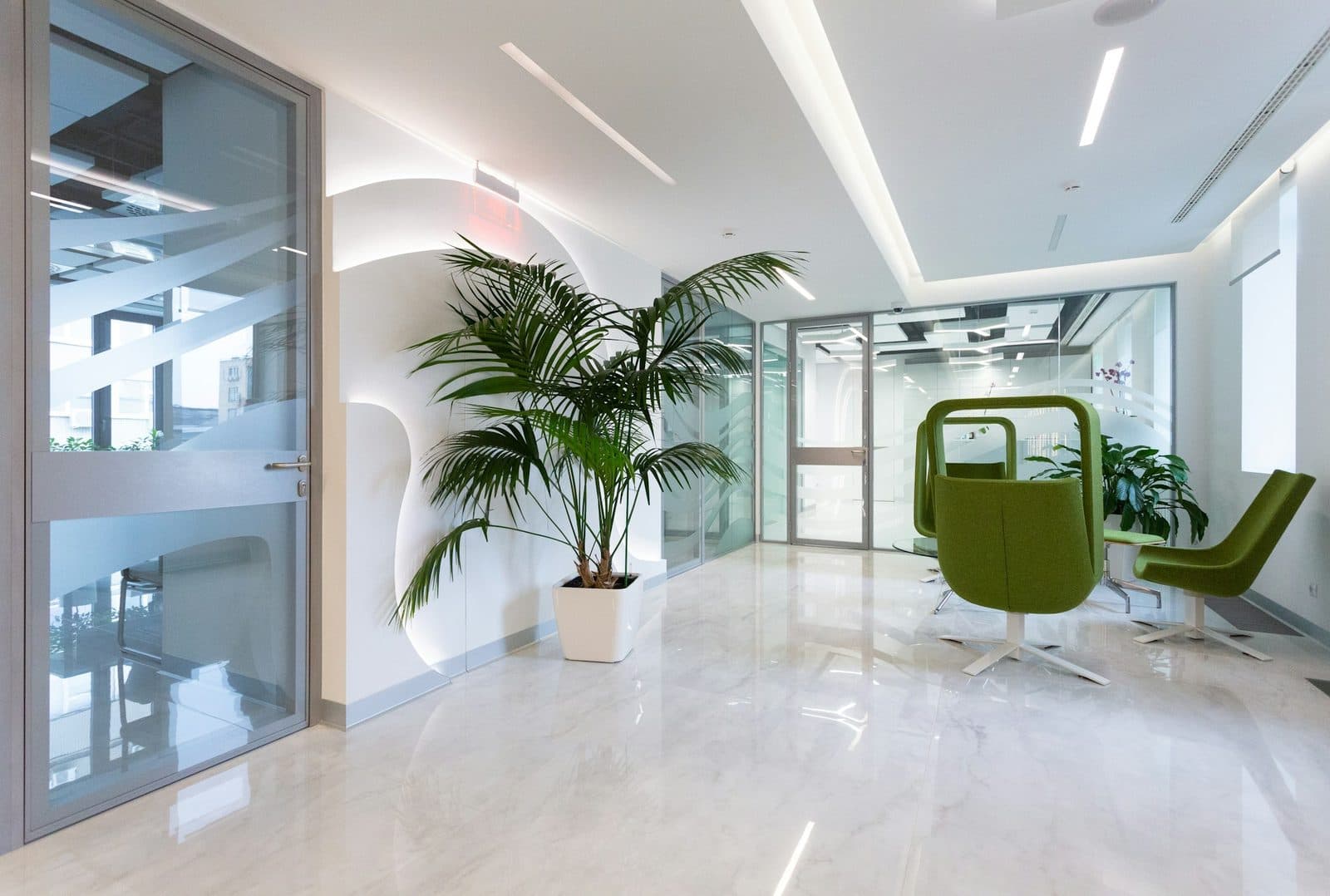 Bright professional suite with glossy large-format tile floors and glass-walled rooms