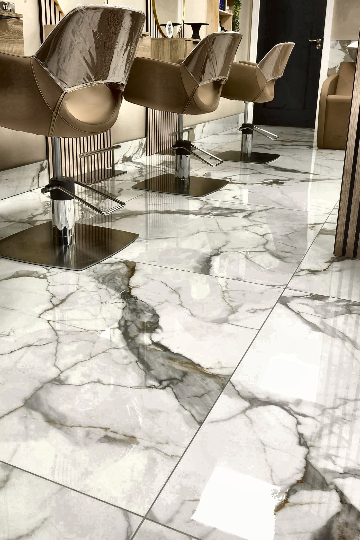 High-gloss white marble floor with mirror reflections of furniture and lights
